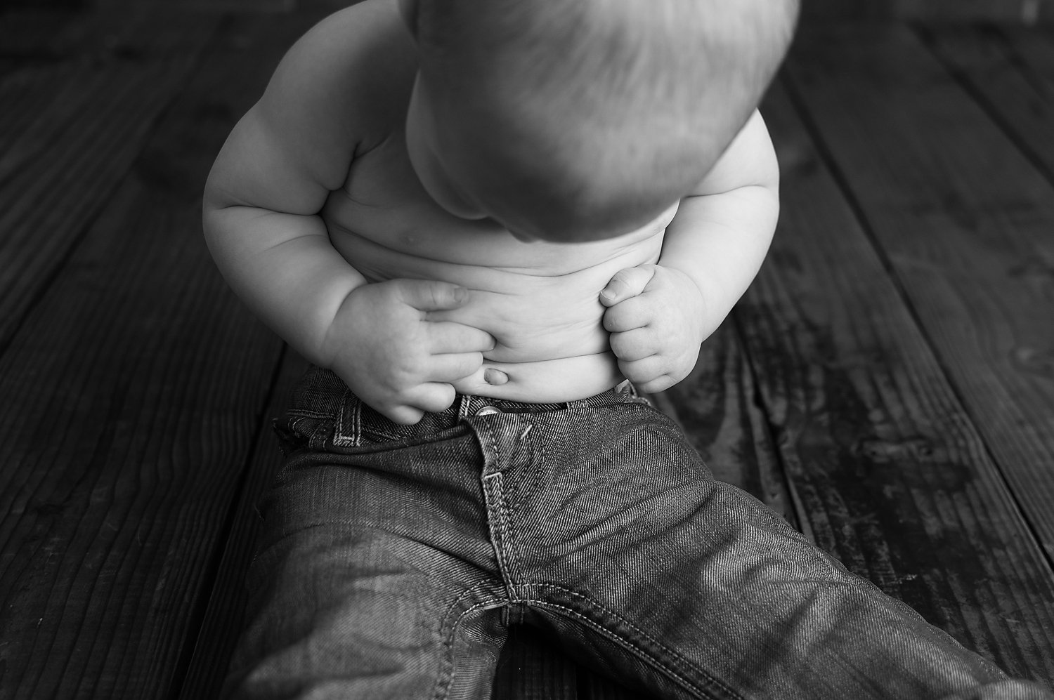 January 20 2016-Tabatha Sue Photography-Brook Park Ohio-Simple Set Up-1st Birthday Boy-Baby Portraits-Northeast Ohio-Wood Backdrop-Baby Jeans-Baby Rolls-Details of Baby-Black and White Photography.jpg